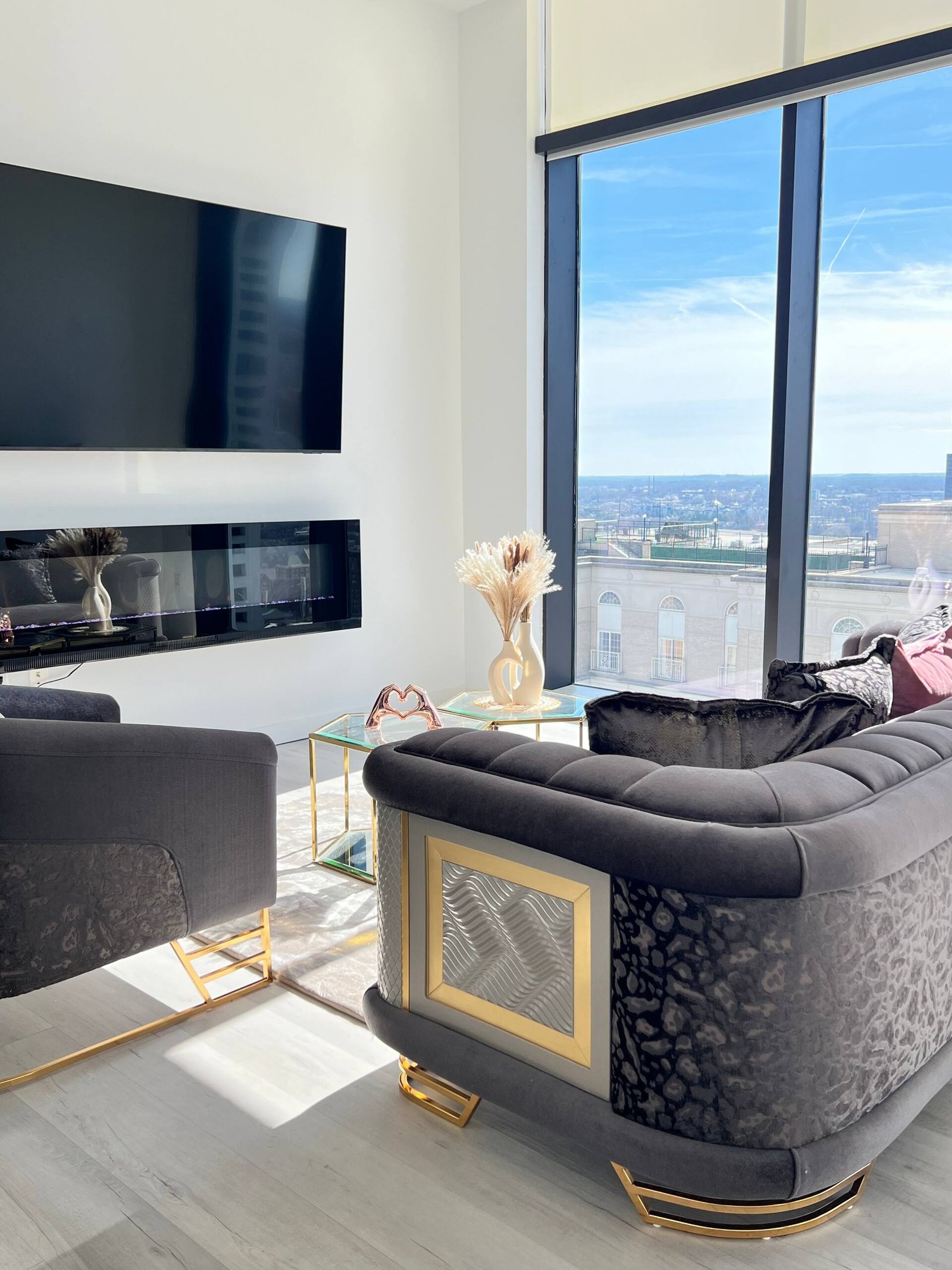 Living area with mounted television and skyline outlook
