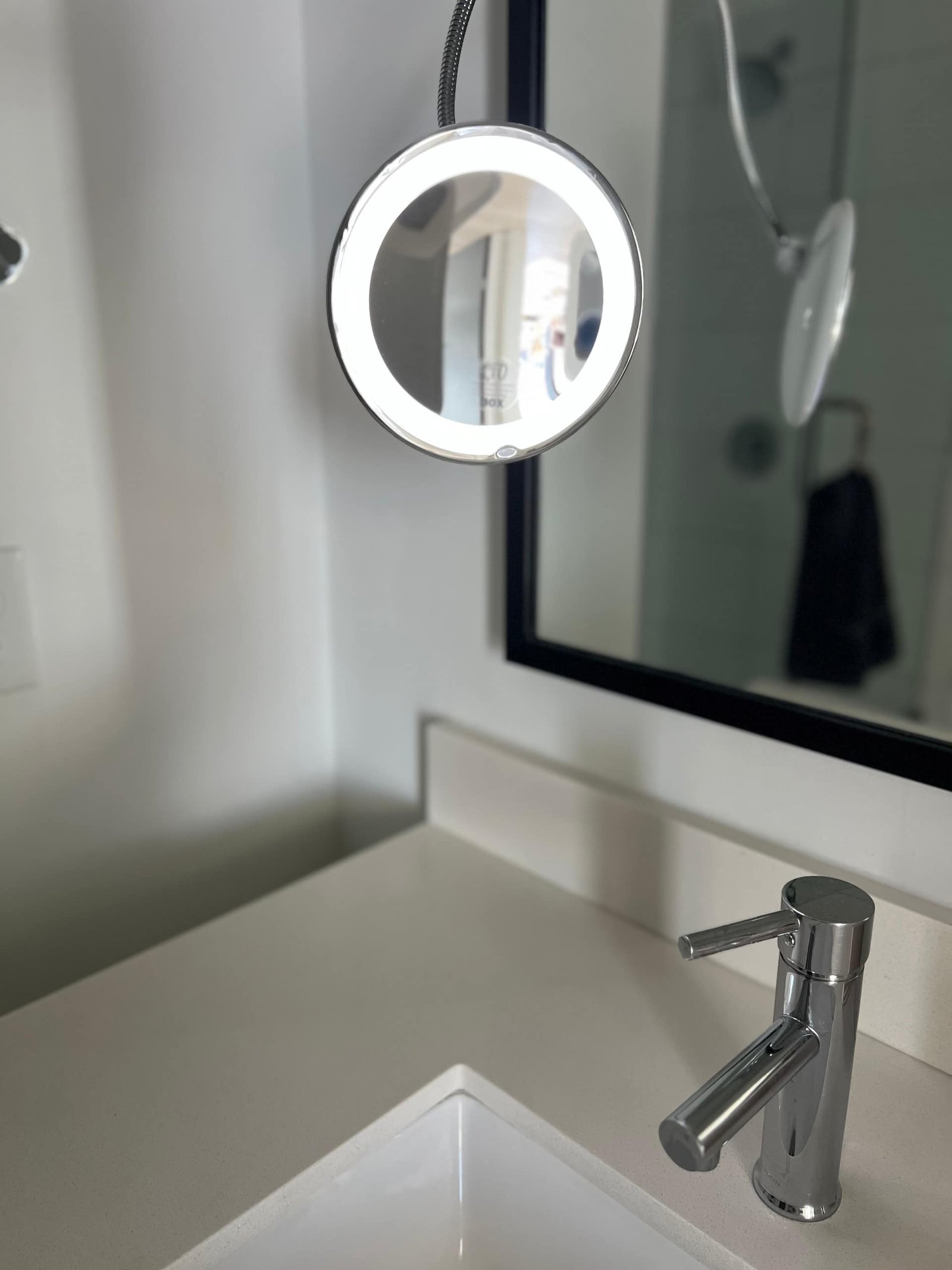 Bathroom vanity with lighted mirror