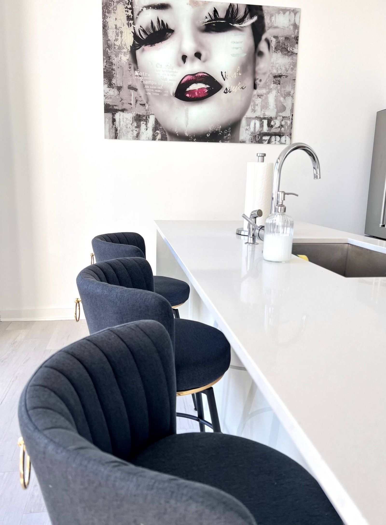 Kitchen island with bar seating and statement artwork