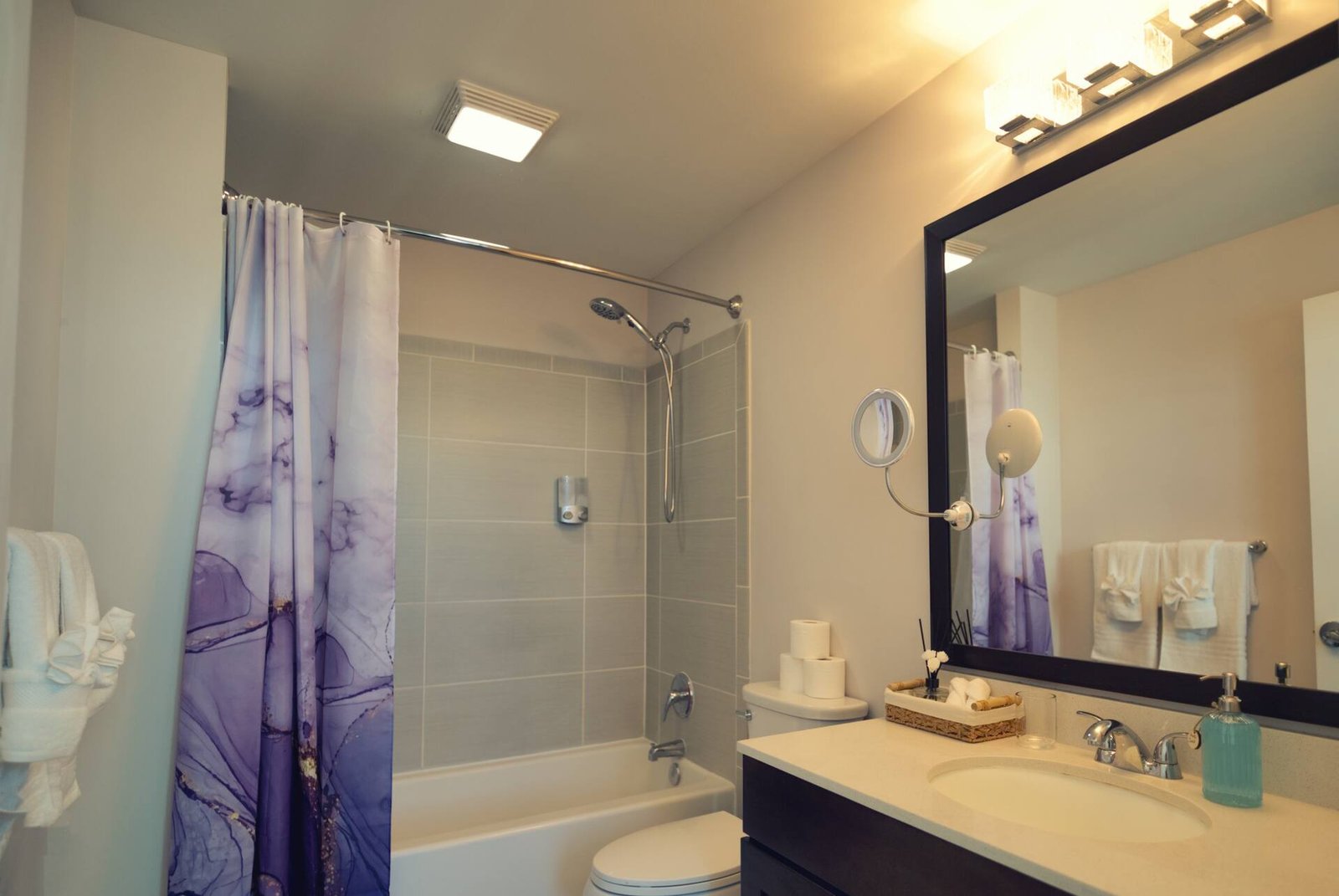 Full bathroom with framed mirror and bathtub