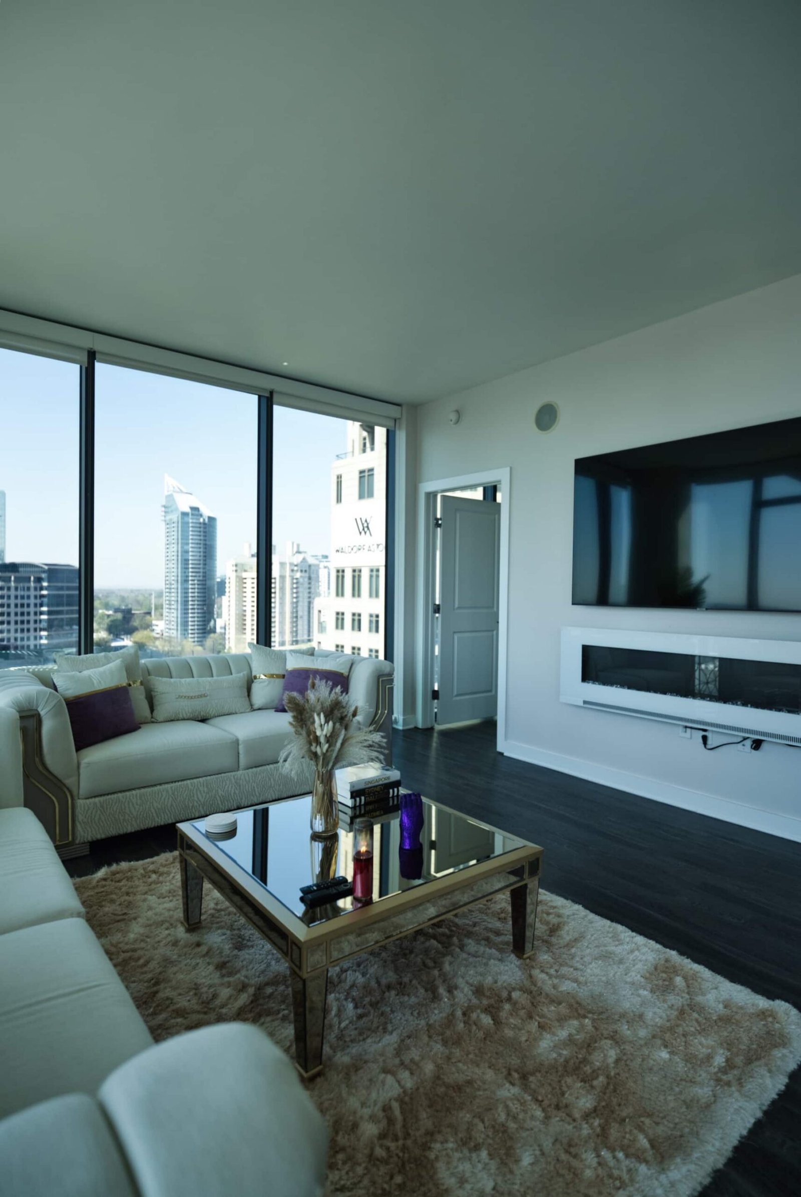 Living space with city view and low glass table